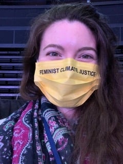 The author in a "feminist climate justice" mask"